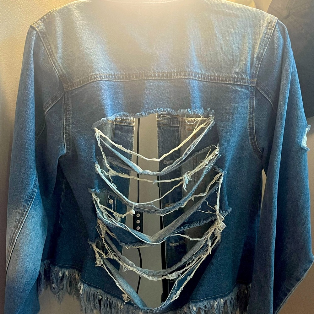 Jeans jacket size large.  Cuts in the back